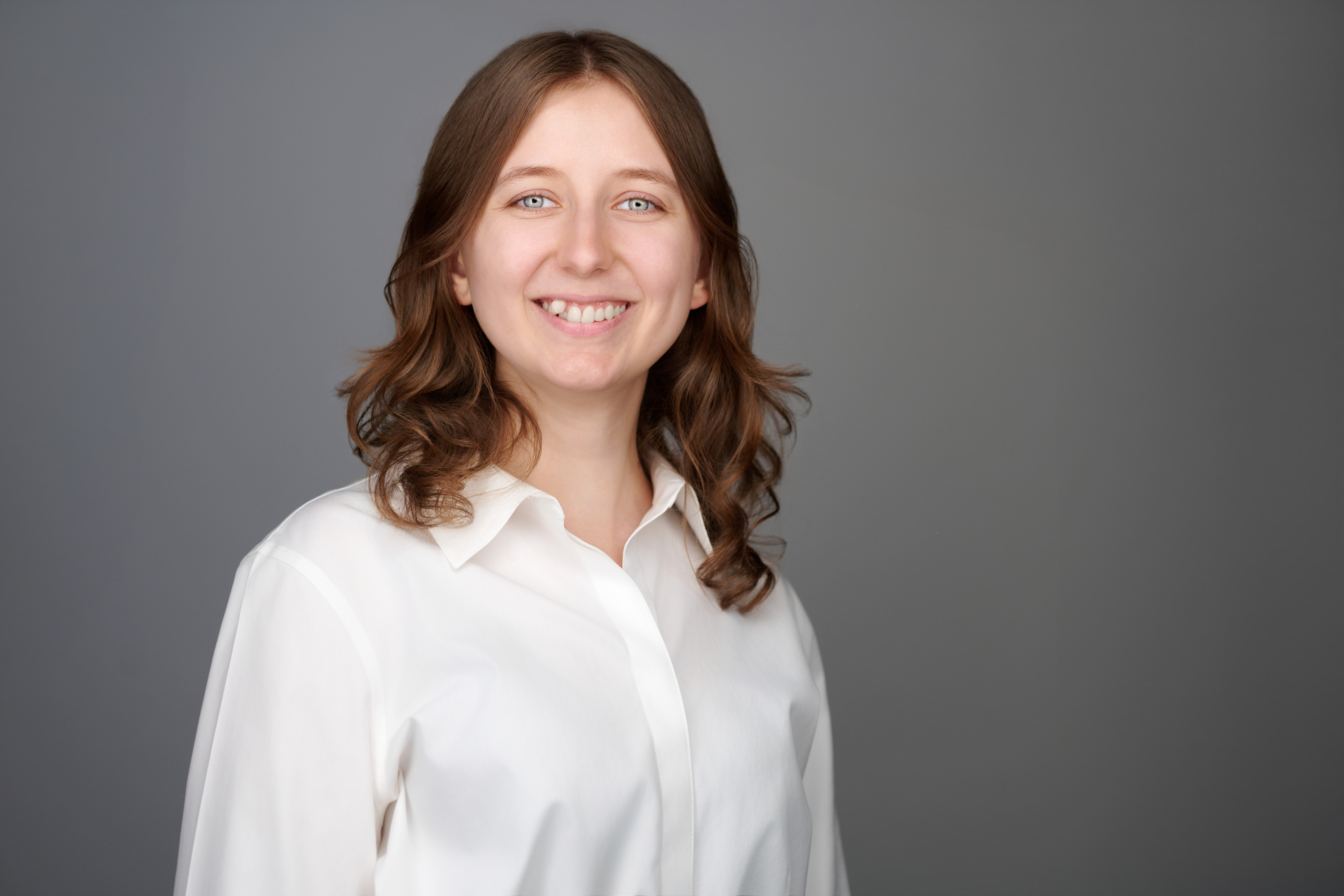 portrait of woman with brown hair and a white shirt